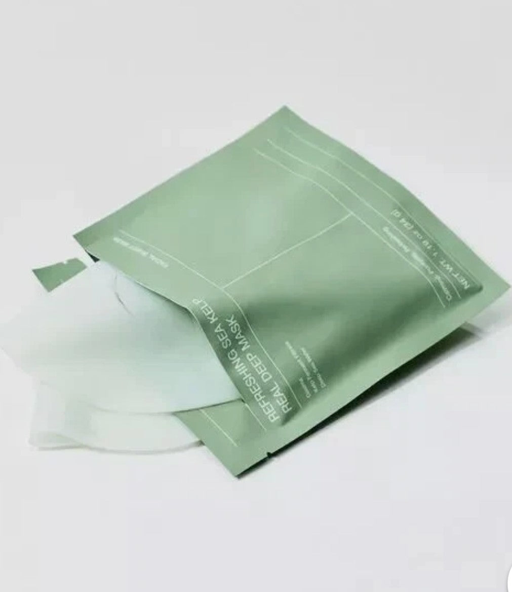 Biodance Sea Kelp Deep Mask opened sheet mask on green background