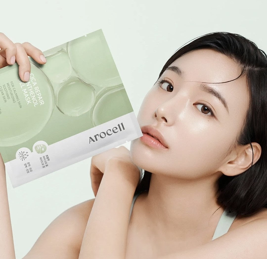 Woman holding a sheet mask with Arocell branding on a light green background