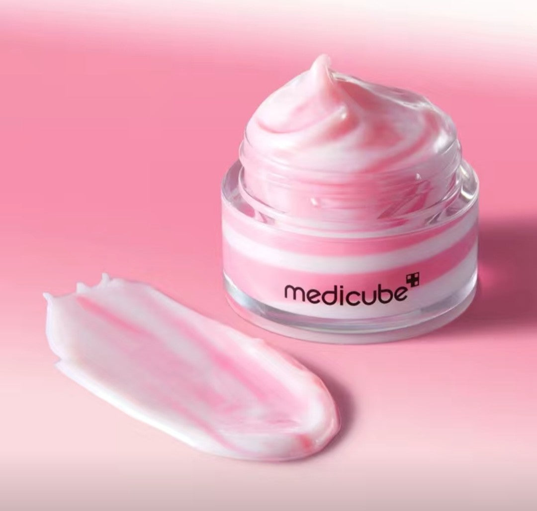 Medicube skincare product with pink cream on a pink background
