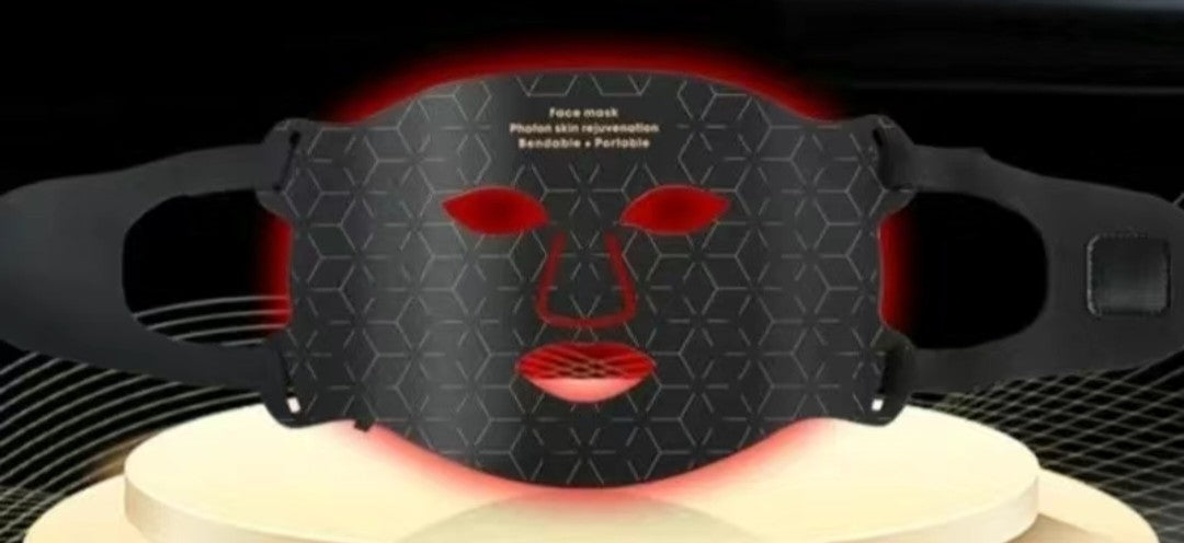 Black face mask with red light on a black background