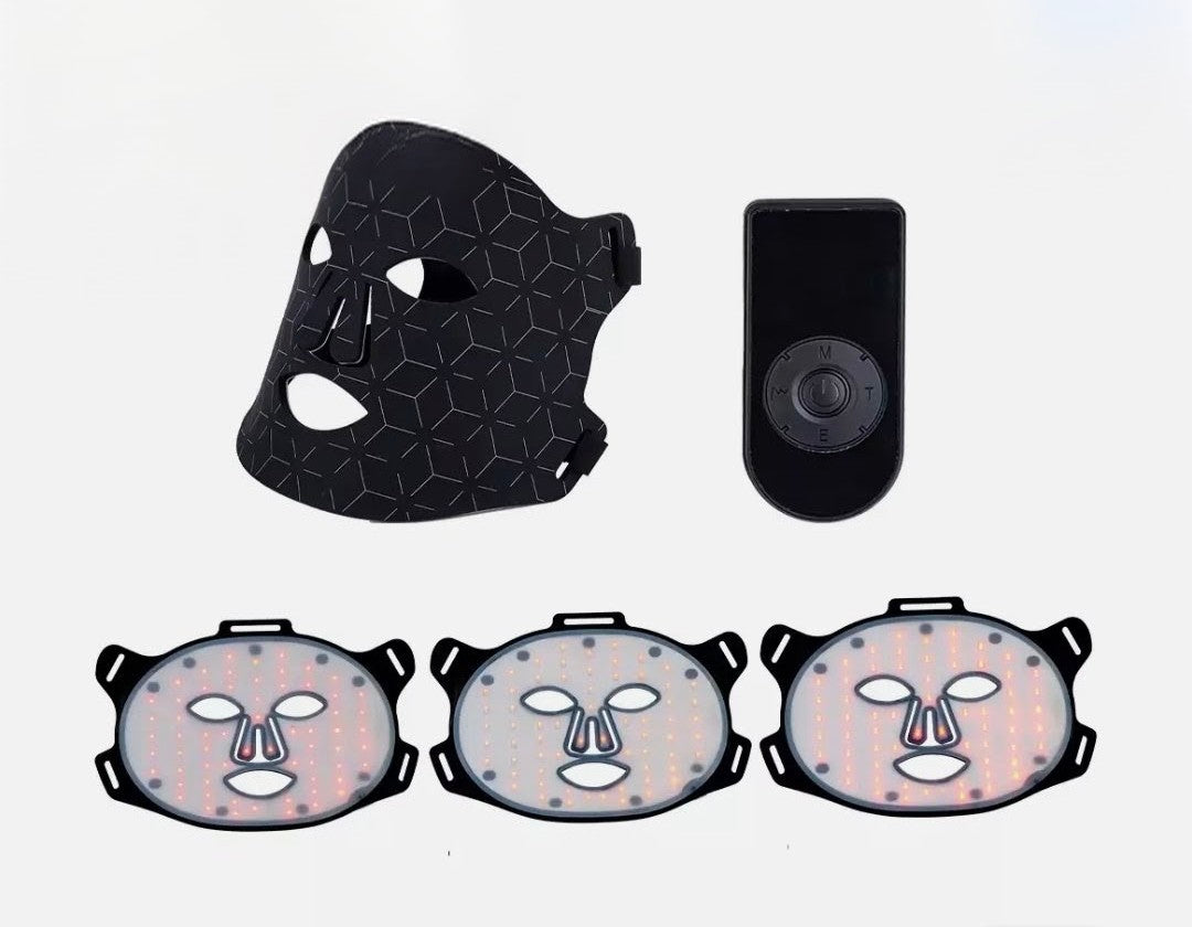 Black face mask with geometric design, black device, and three face-shaped masks on a white background