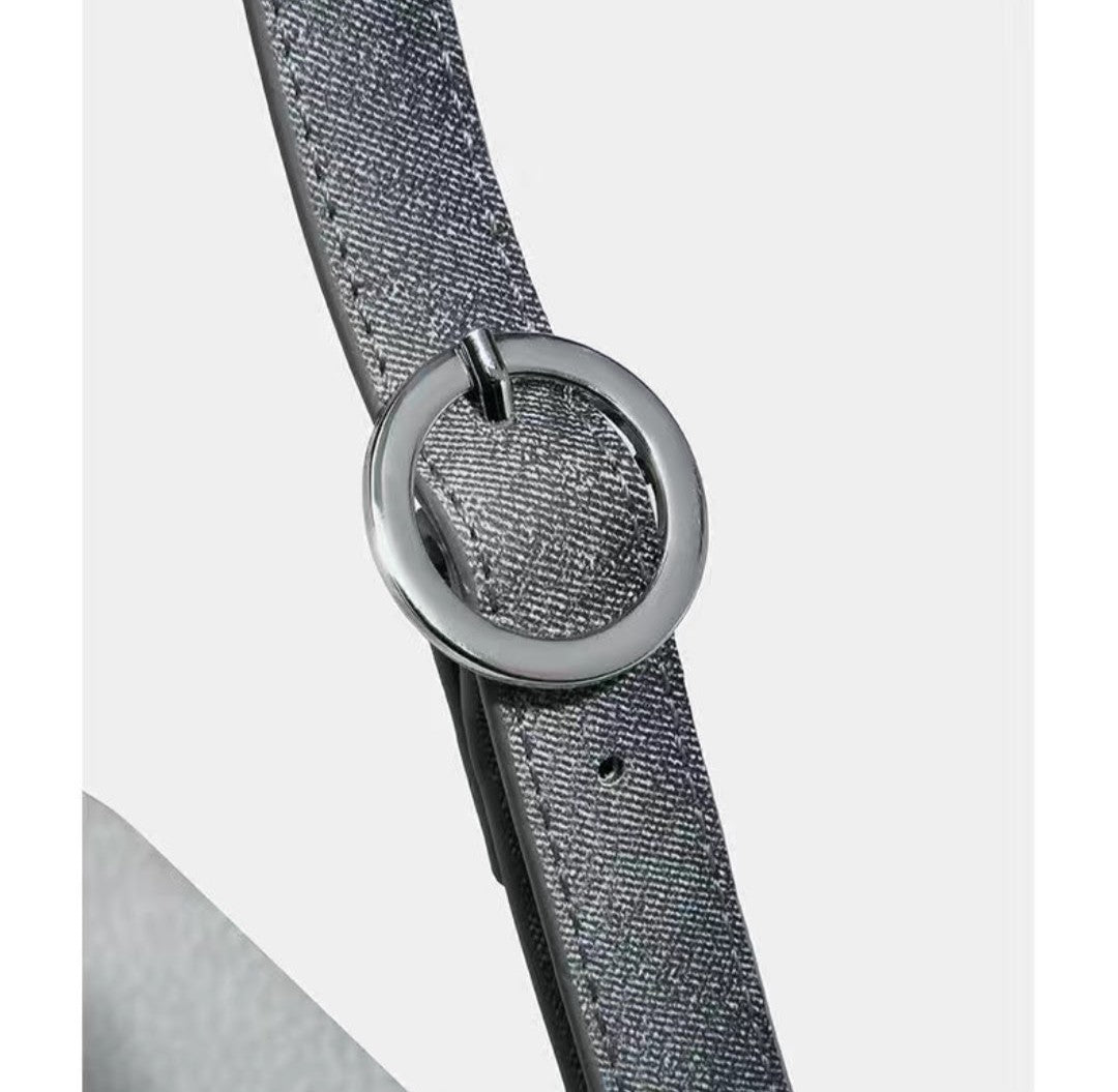 Gray belt with a round metal buckle on a light gray background