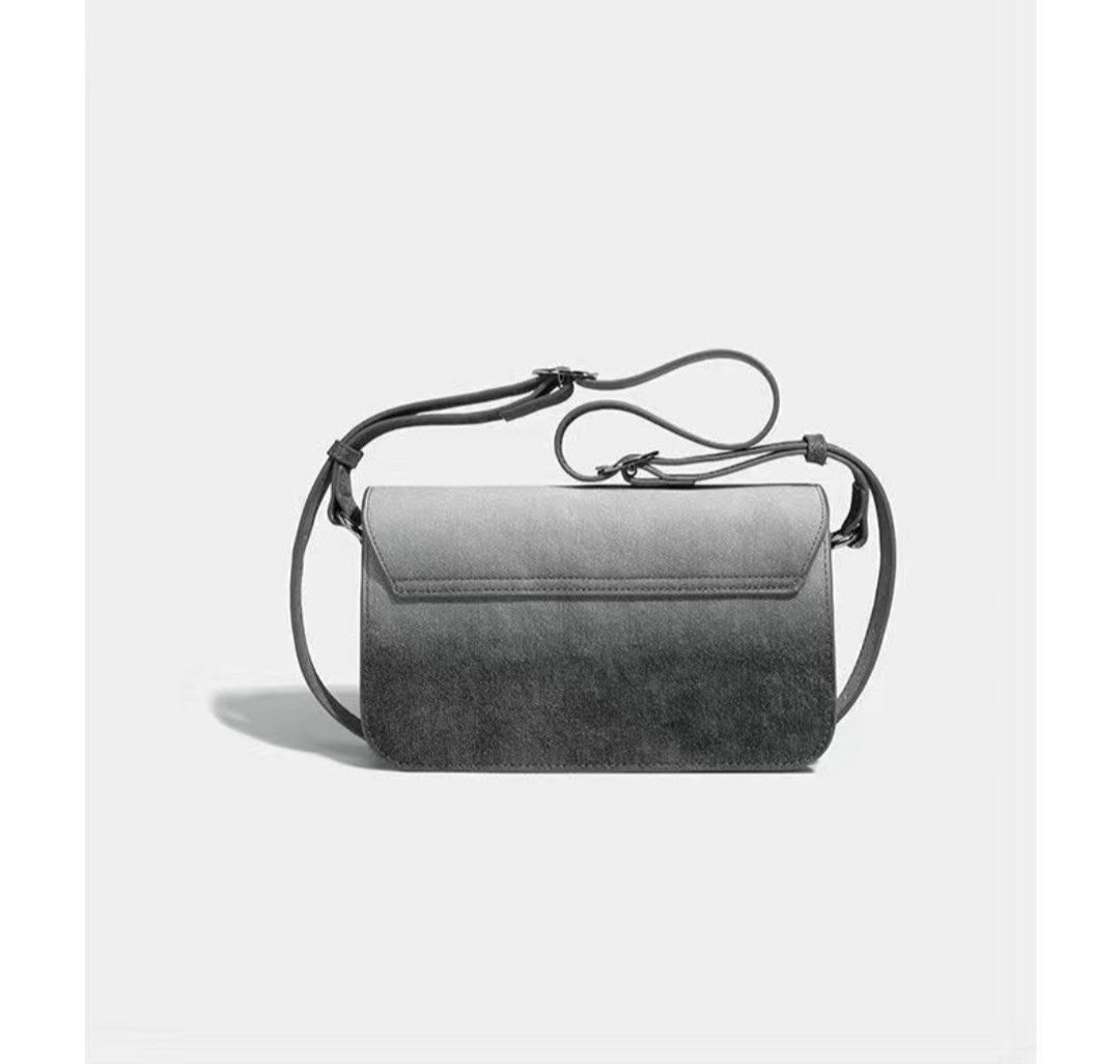 Gray handbag with a strap on a light gray background