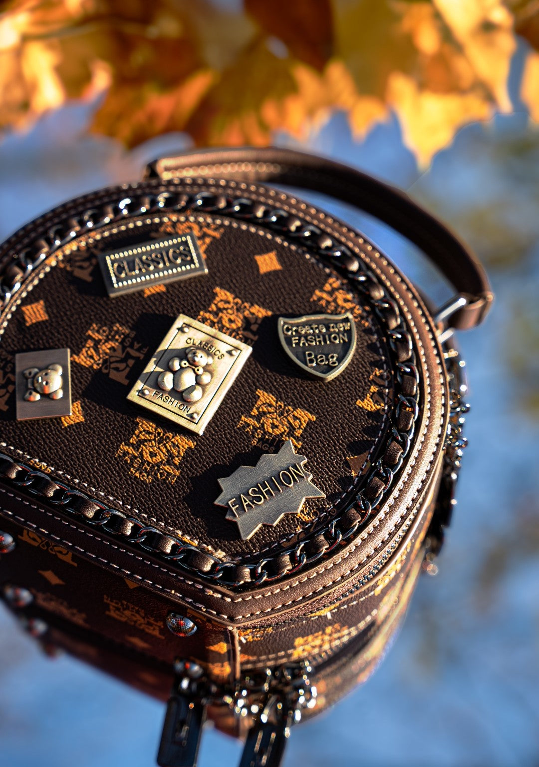 Decorative bag with decorative pins against a blurred natural background