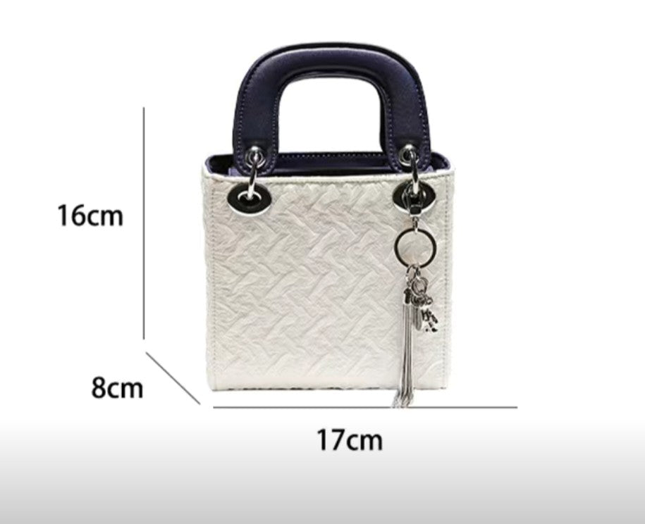 Dimensions of GlowBags white and navy mini handbag – 17cm x 16cm x 8cm