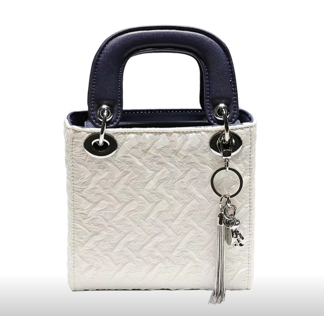 Elegant white and navy mini handbag from GlowBags Collection with embossed PU leather and silver charm