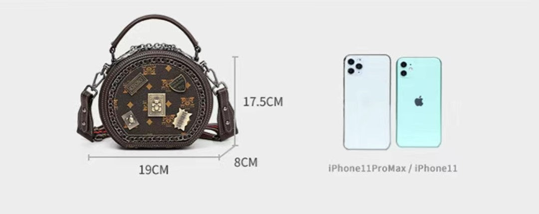 Black handbag with measurements and two smartphones for scale on a white background