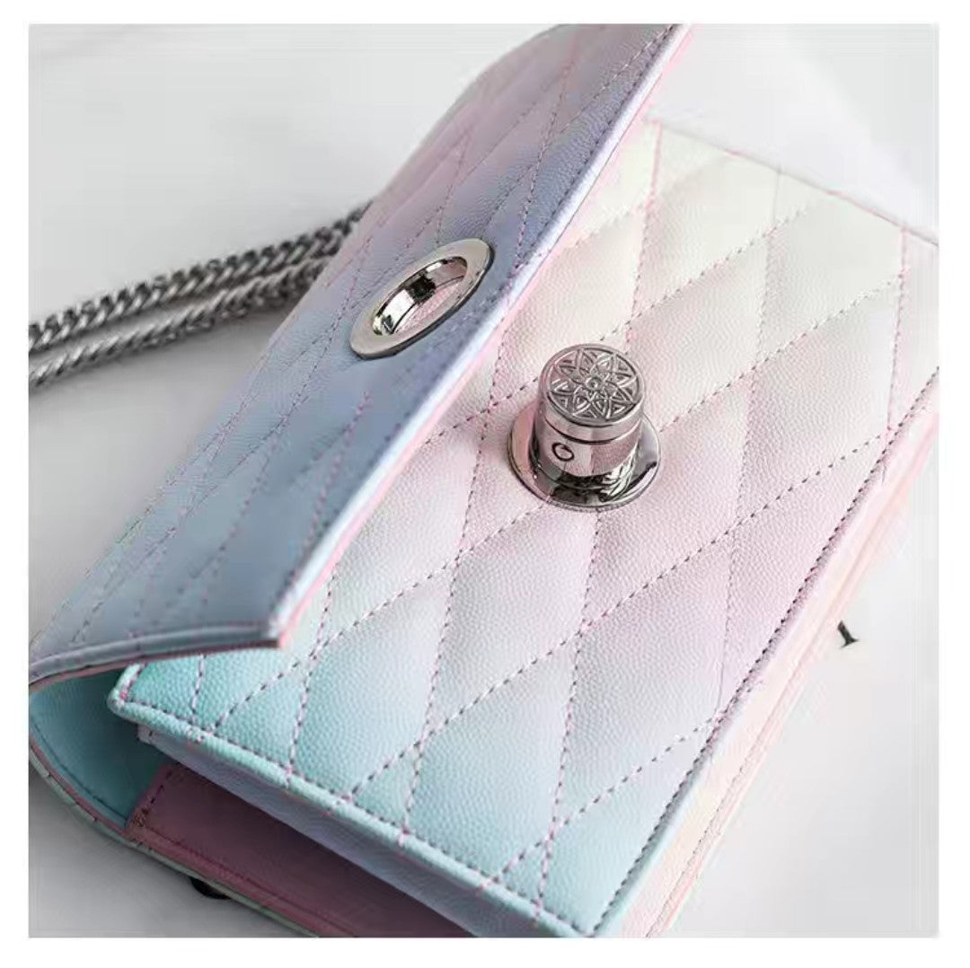 Close-up of a quilted handbag with a metal clasp on a light background