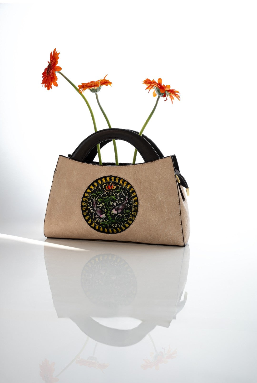 Beige handbag with floral design on a white background