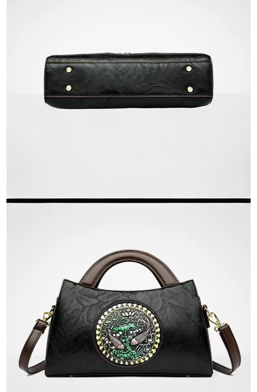 Black handbag with decorative emblem on a white background