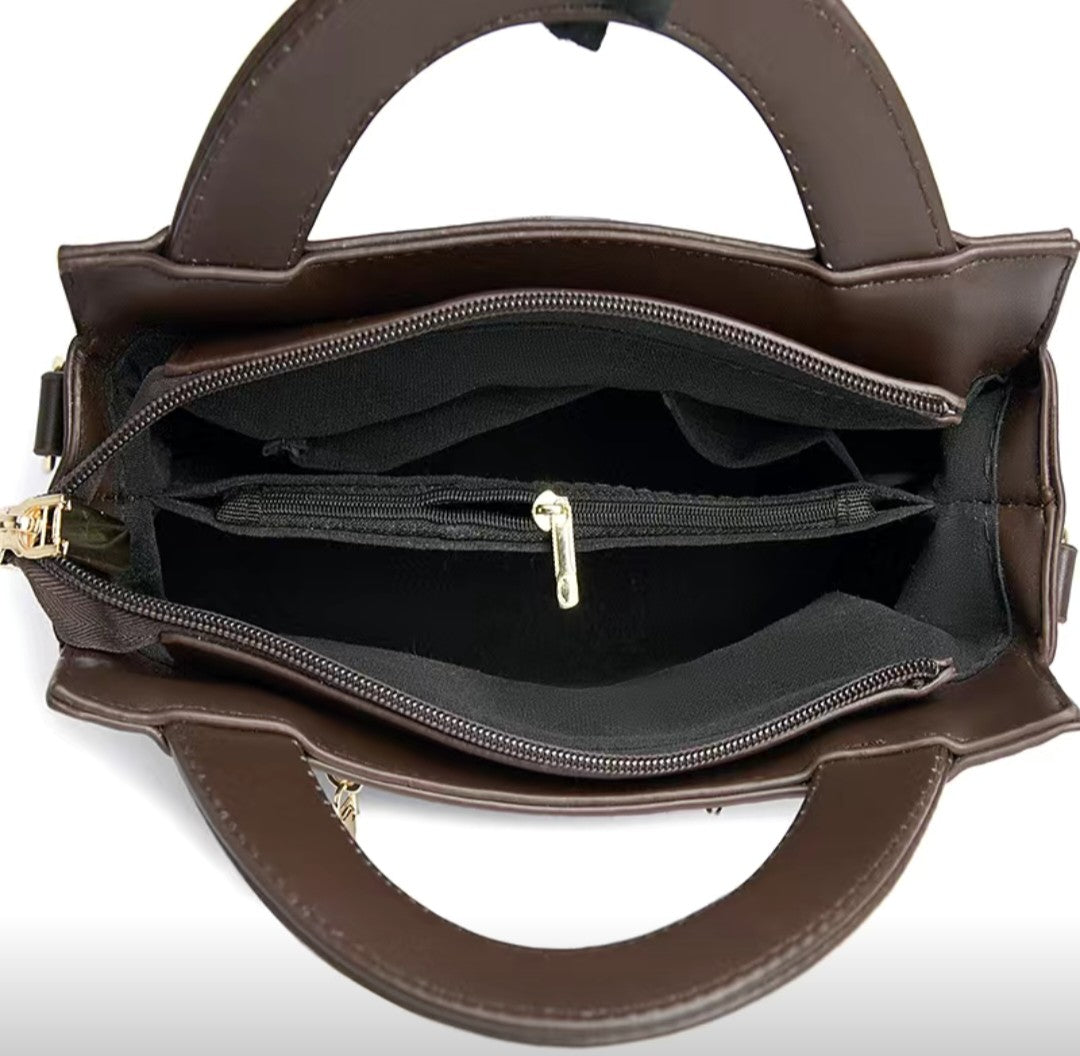 Brown handbag with open compartments on a white background