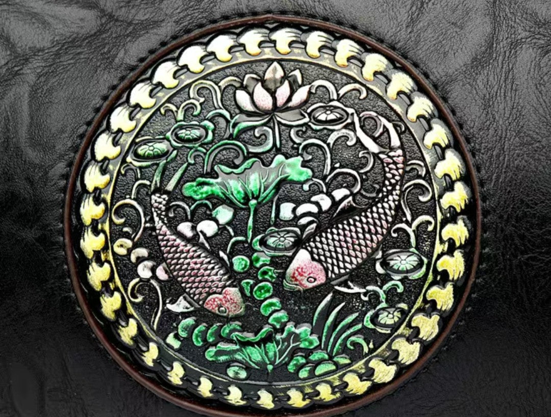 Decorative round emblem with fish and lotus design on a textured surface