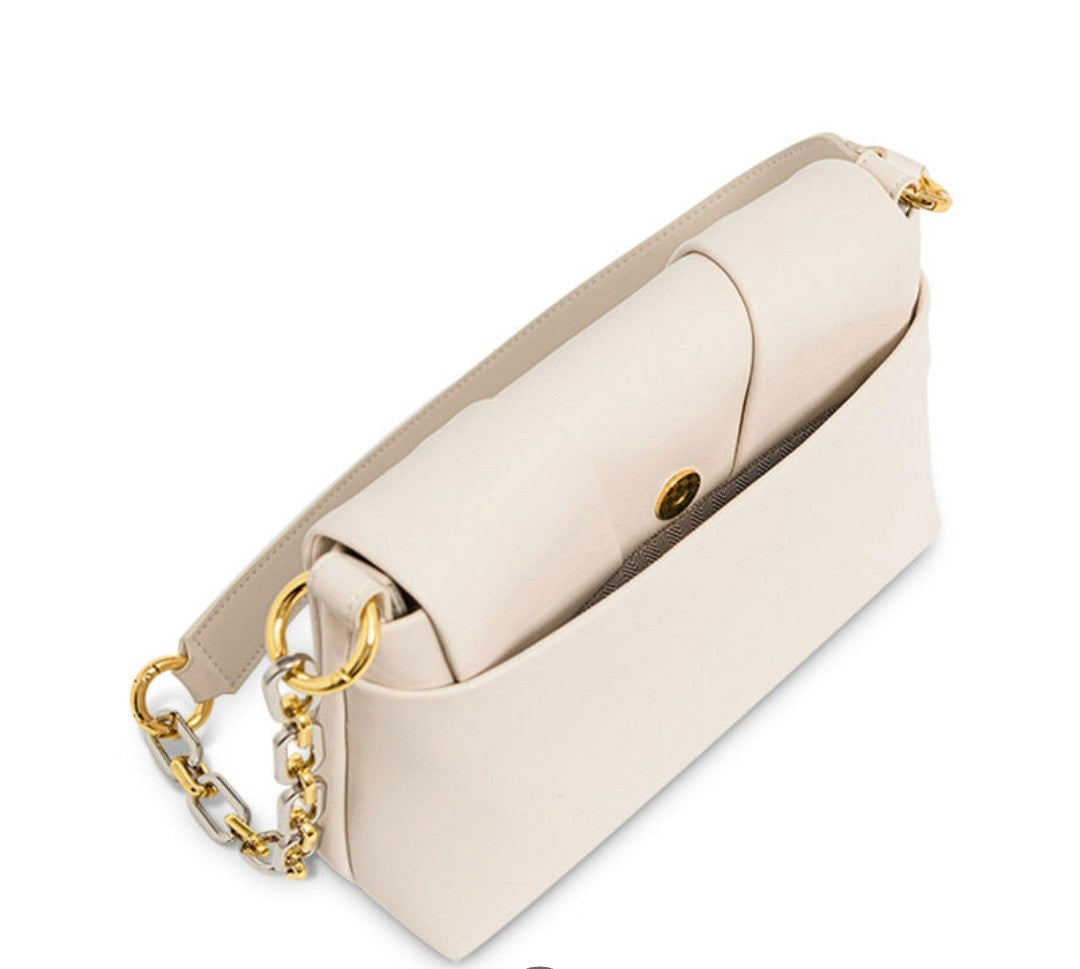Beige handbag with gold chain detail on a white background