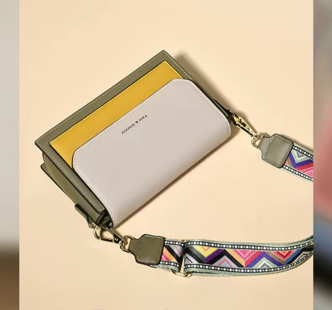 Handbag with a colorful strap on a beige background