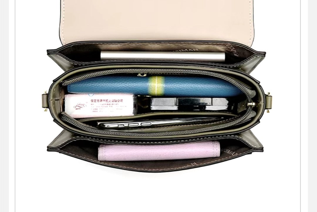 Open handbag with stationery items on a white background