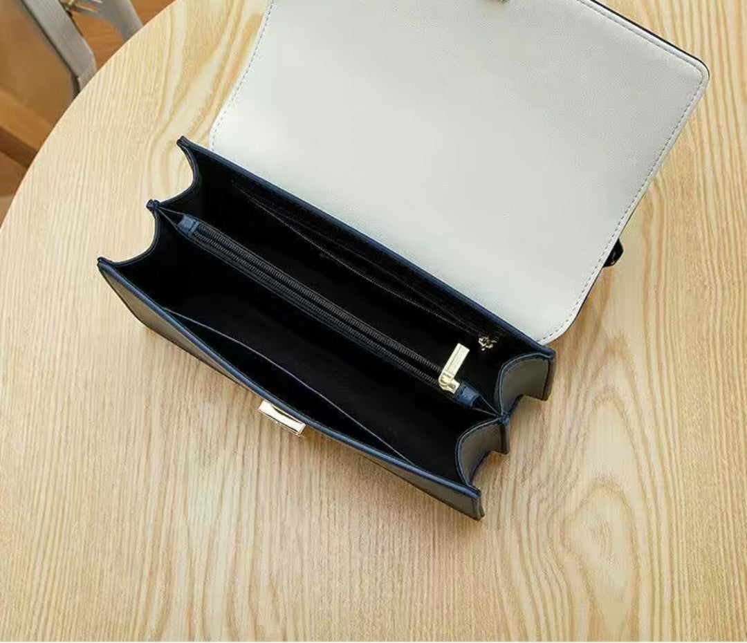 Black and white handbag on a wooden surface