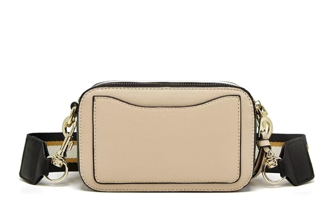 Beige crossbody bag with black straps on a white background