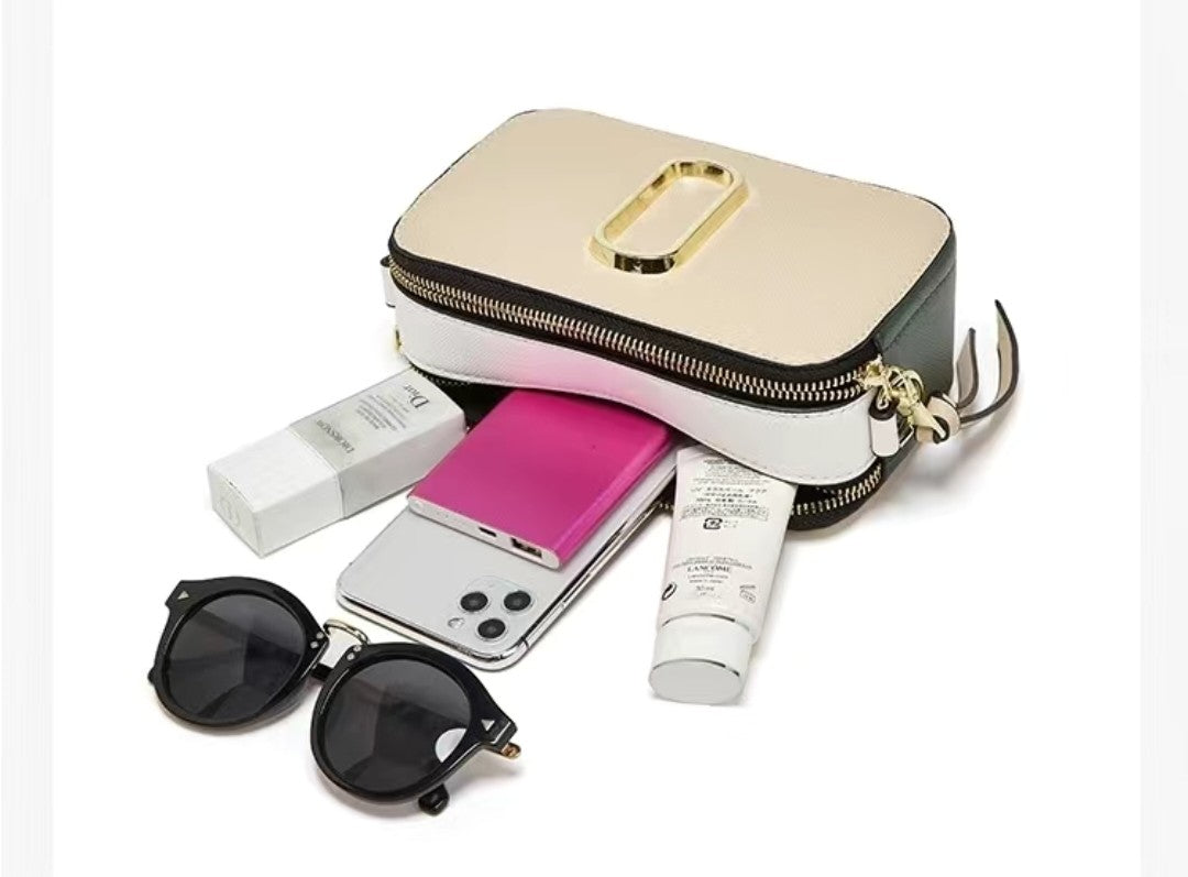 Small travel bag with sunglasses, phone, and toiletries on a white background