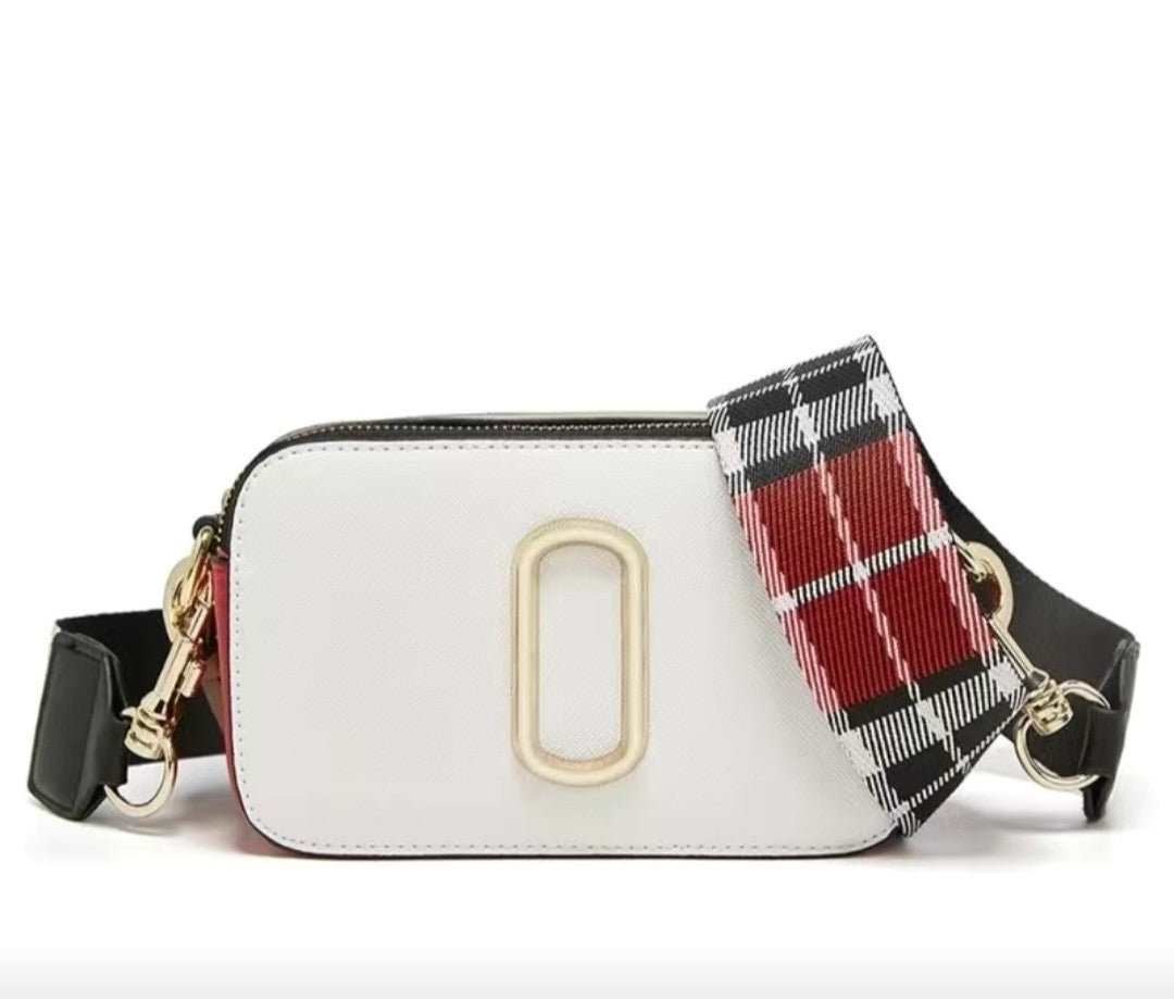 White handbag with a plaid strap on a white background