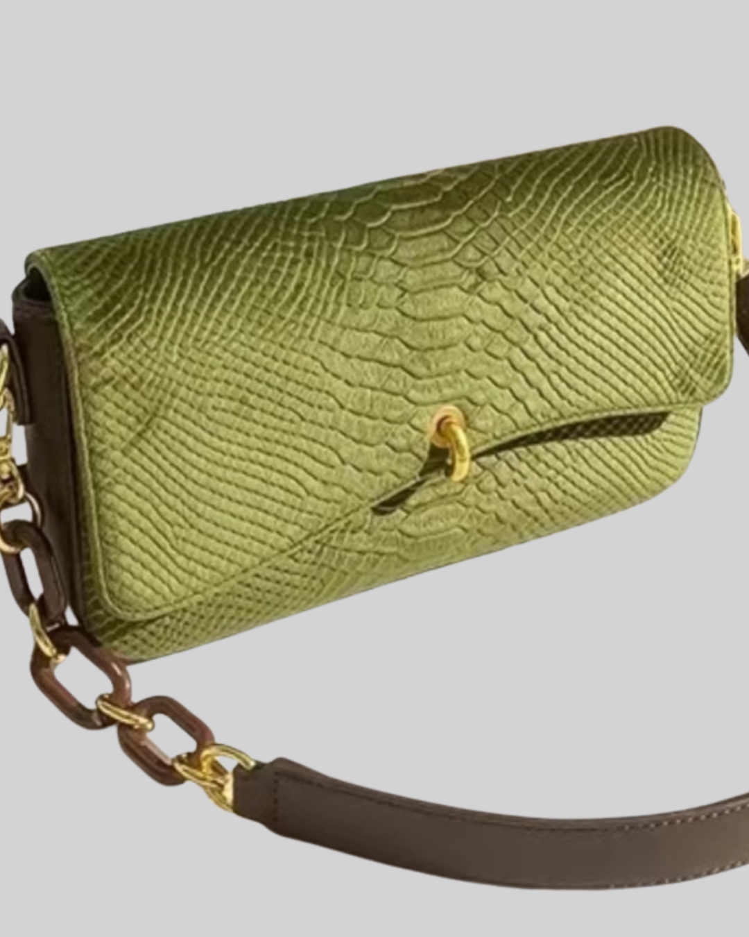 Green textured handbag with a gold chain strap on a light gray background