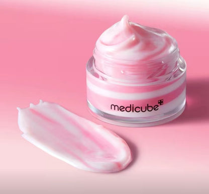 Jar of Medicube cream with pink cream on a pink background