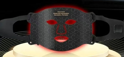 Black face mask with red light on a black background