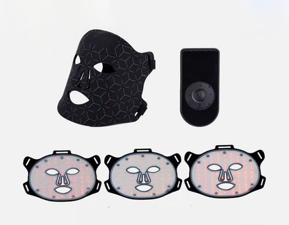 Black face mask with geometric design, black device, and three face-shaped masks on a white background