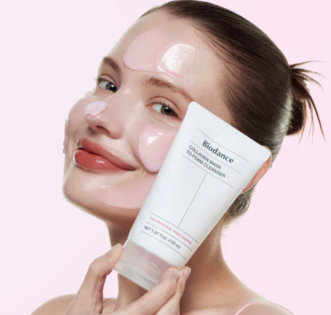 Woman holding a skincare product with a pink background