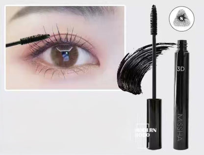 Woman applying Missha 3D Mascara for long, curled lashes
