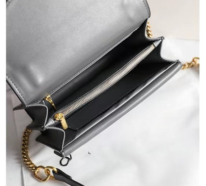 "Interior view of grey crocodile-embossed shoulder bag with gold chain and zip compartments"
