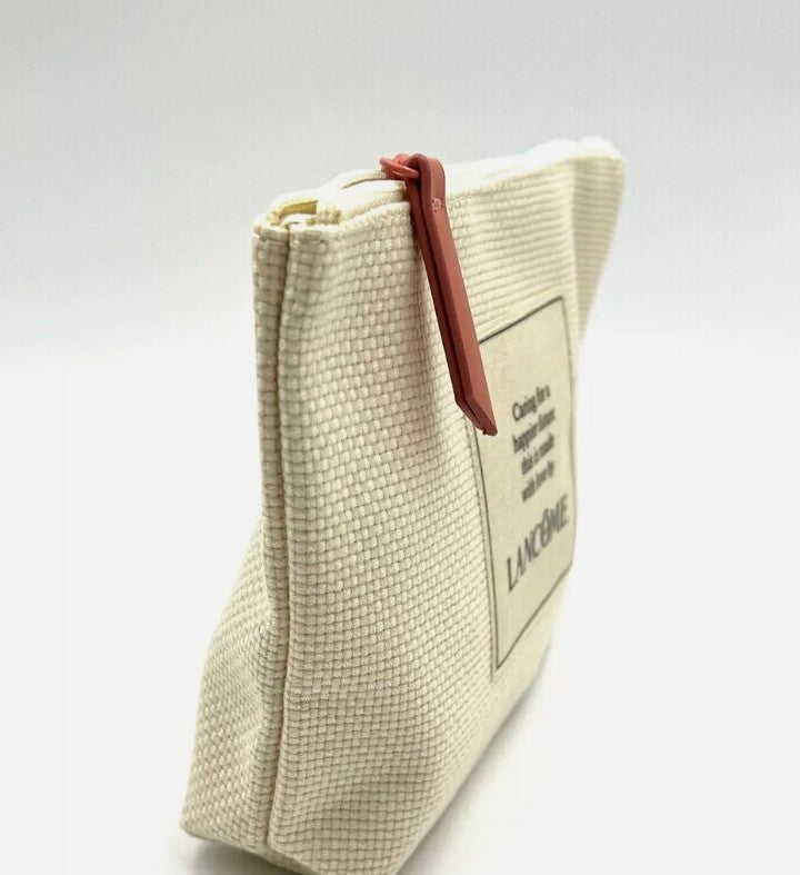 Beige makeup bag with brown zipper on a light gray background