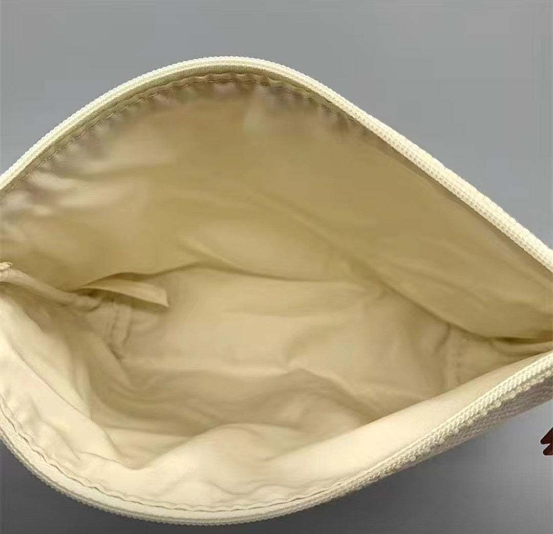 Beige pouch with a zipper on a gray background