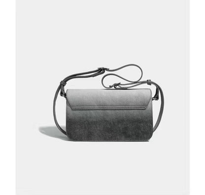 Gray handbag with a strap on a light gray background