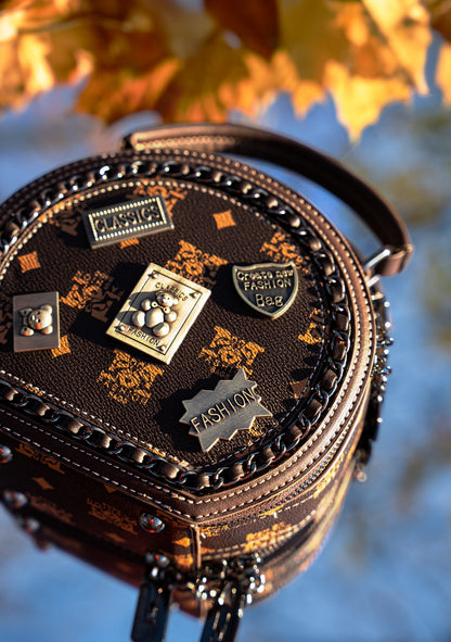 Decorative bag with decorative pins against a blurred natural background
