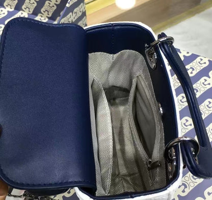 Inside view of GlowBags white and navy mini handbag with spacious compartment

