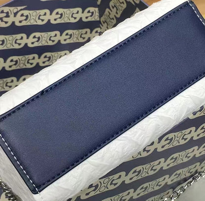 Close-up of navy PU leather handle on GlowBags elegant white mini handbag
