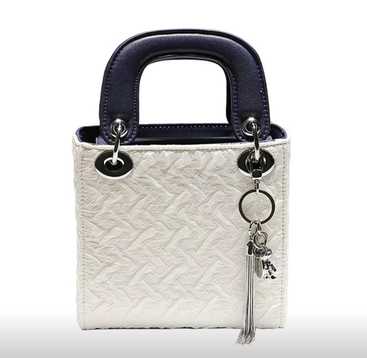 Elegant white and navy mini handbag from GlowBags Collection with embossed PU leather and silver charm
