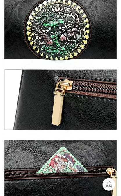 Black bag with decorative emblem and gold zipper