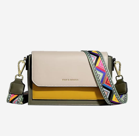 Multicolored handbag with a colorful strap on a white background