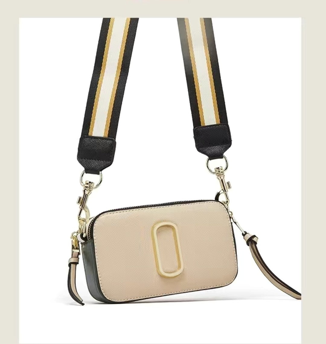 Beige handbag with a striped strap on a light beige background