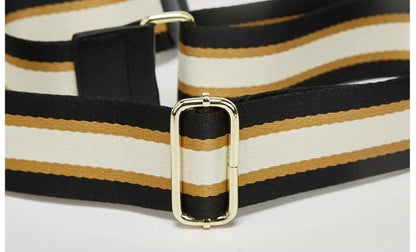 Close-up of a striped belt with a gold buckle on a white background