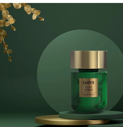 Green perfume bottle with gold cap on a green background