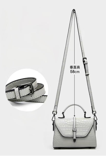 Gray handbag with a strap and measurements on a white background
