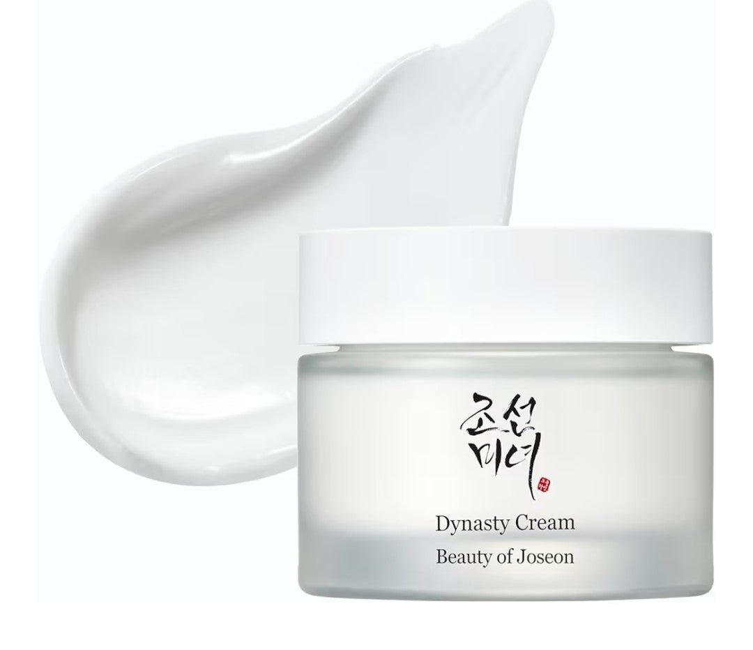 Jar of Dynasty Cream with a smear of cream above it on a white background