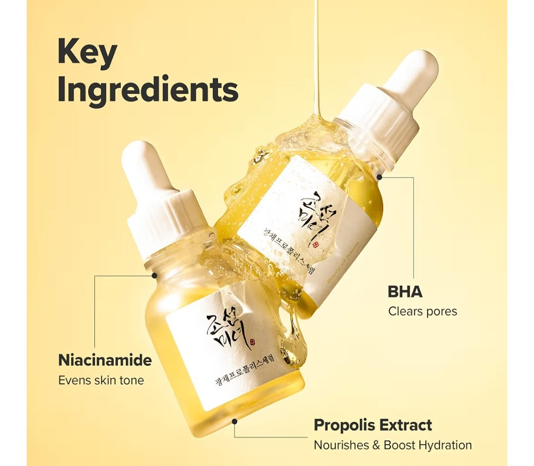 Skincare dropper bottle with key ingredients labeled on a yellow background