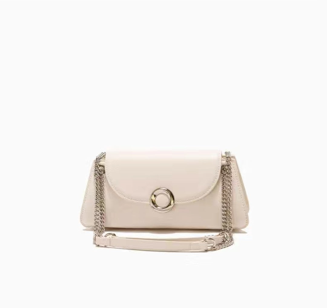 White handbag with chain detail on a white background