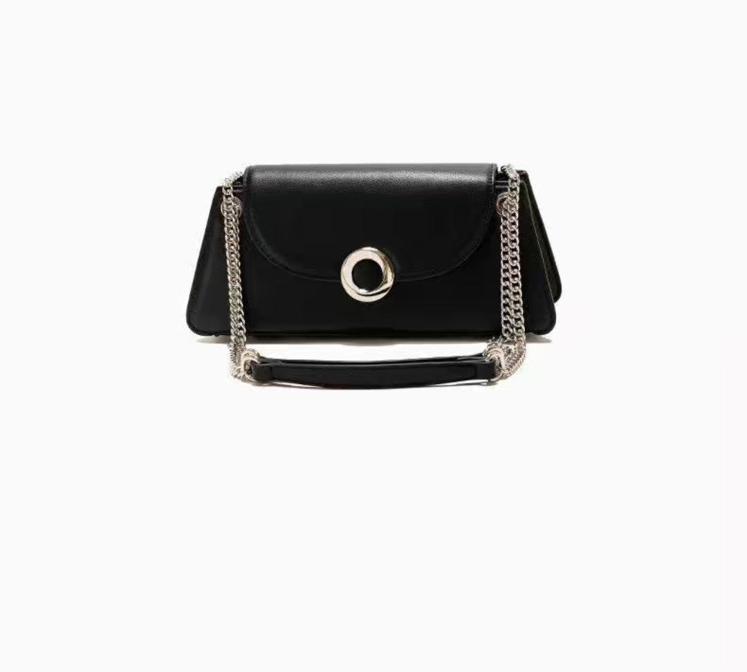 Black handbag with a chain detail on a white background