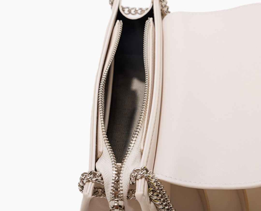 Close-up of a beige handbag with a zipper on a white background